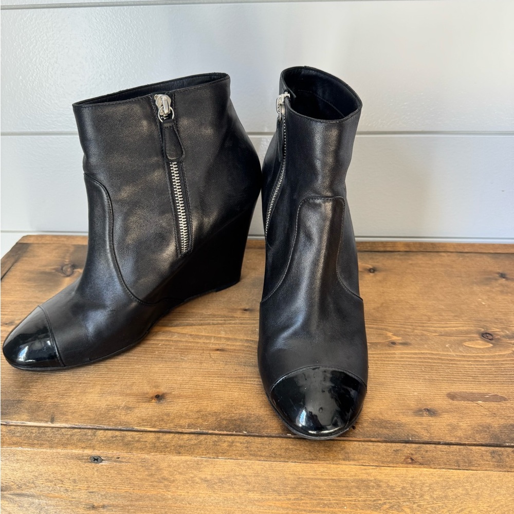CHANEL Black Leather Ankle Booties with patent leather toe.
